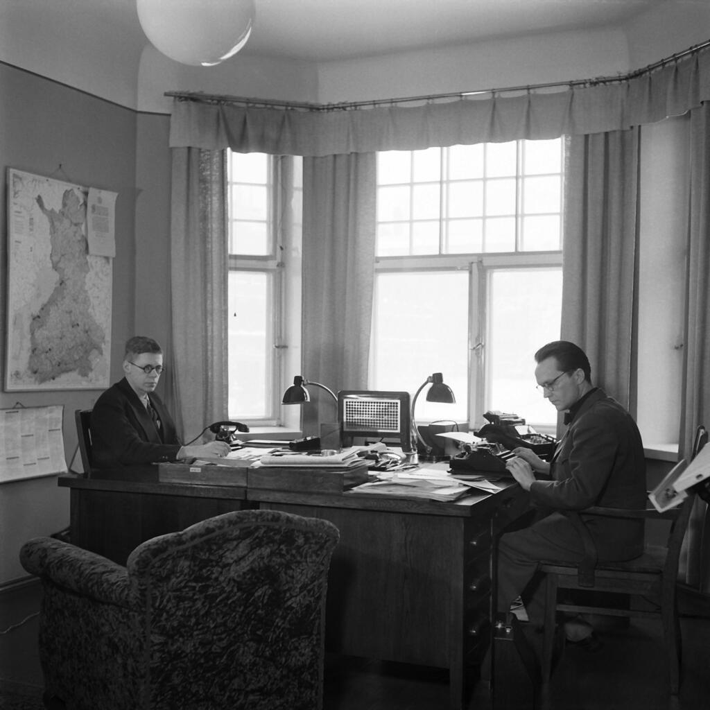 men sitting at desks