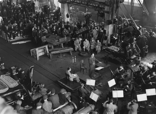 group of people listening to an orchestra concert, top view, black and white photo