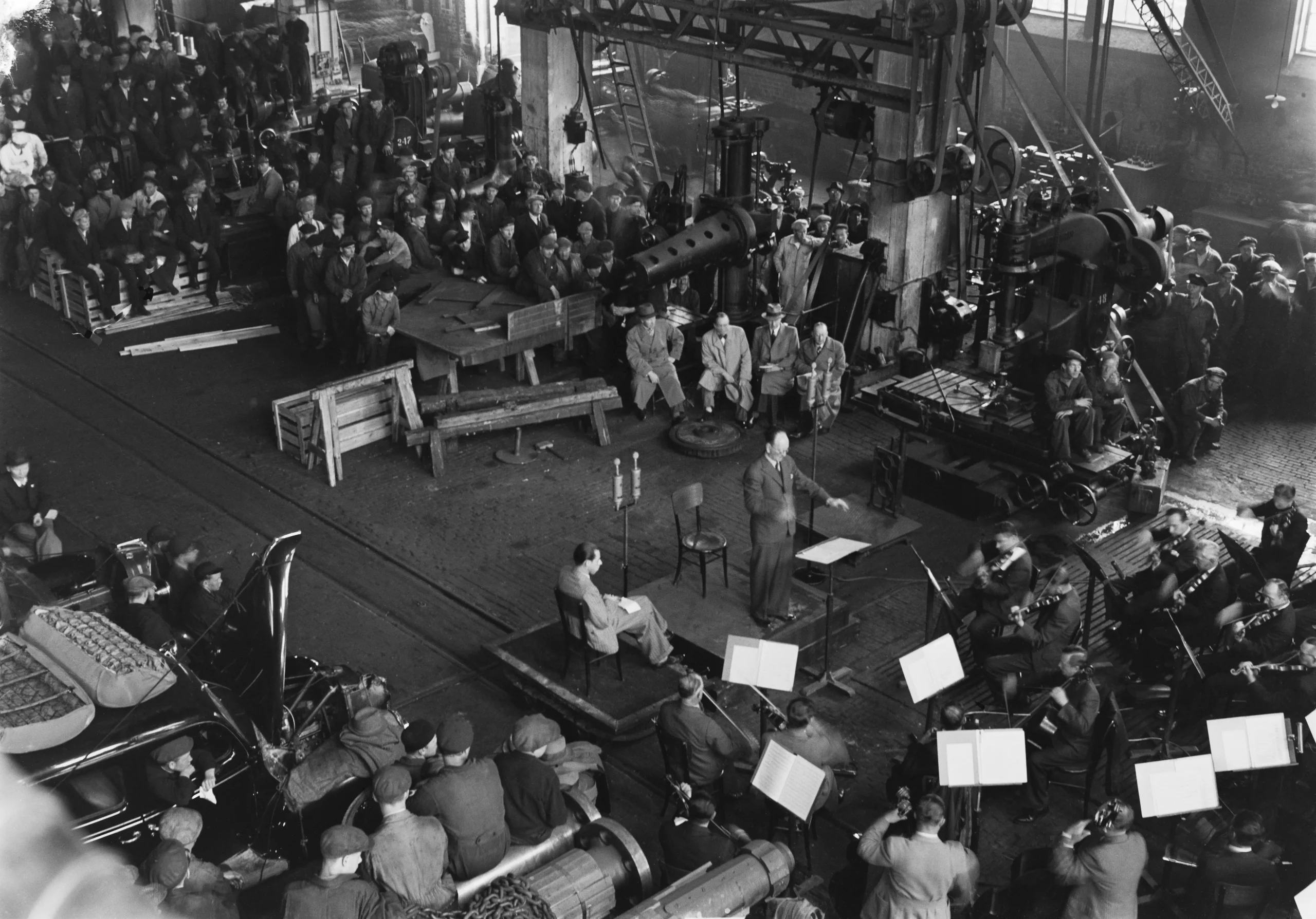 group of people listening to an orchestra concert, top view, black and white photo